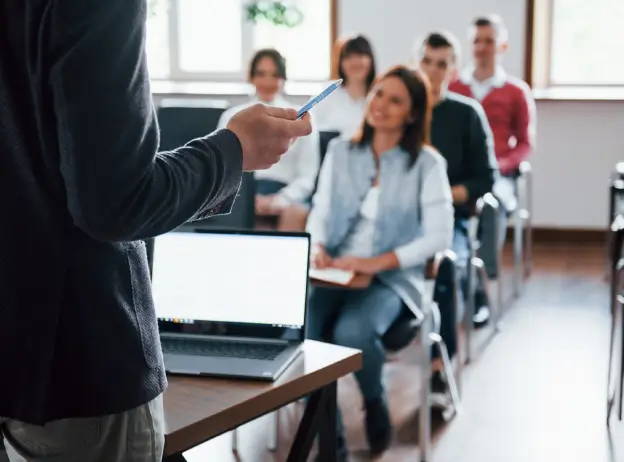 Teacher presenting lesson to students in classroom for digital education platform concept