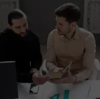 Professionals discussing custom software solutions and business requirements in collaborative workspace