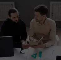 Professionals discussing custom software solutions and business requirements in collaborative workspace